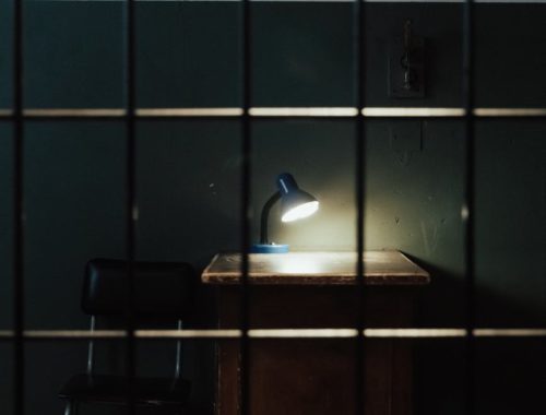 lamp on deck behind bars